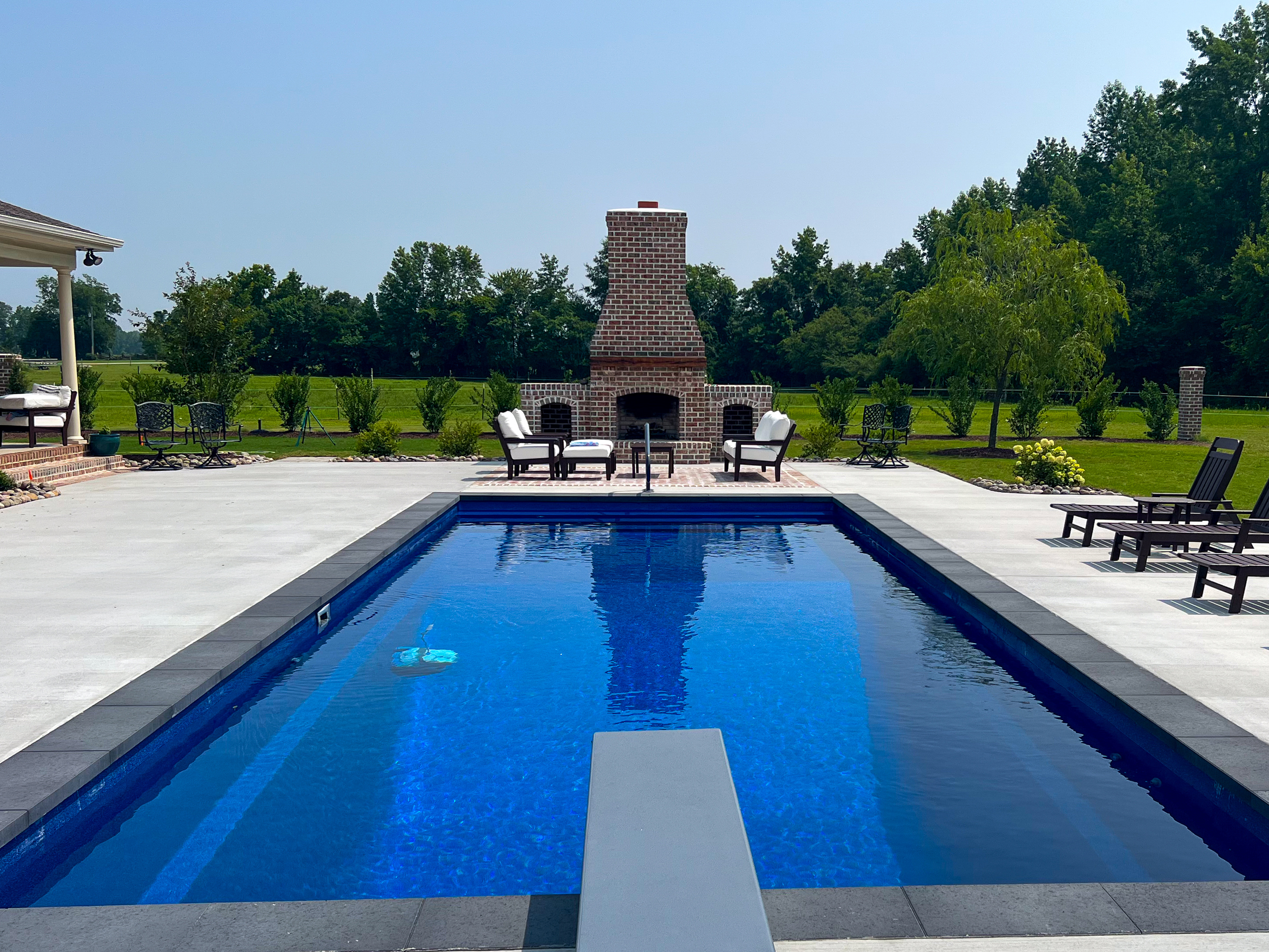 Beautifully landscaped outdoor living space by Yardie Design, Greenville NC
